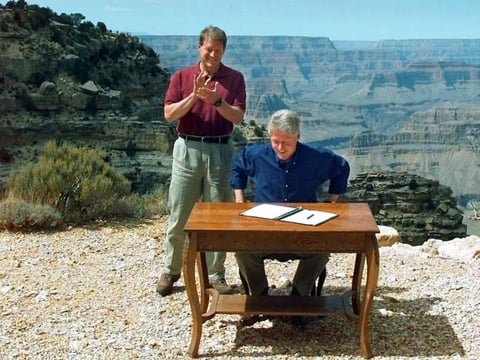 President Bill Clinton, with Vice President Al Gore, signs his 1996 order designating the Grand Staircase-Escalante National Monument in Utah. Opponents continue to note that Clinton made this move while sitting at the Grand Canyon — in Arizona.